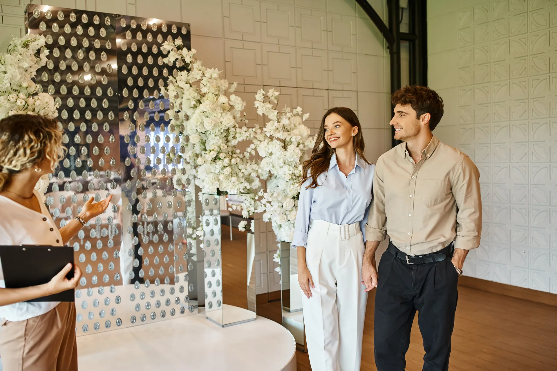 Florist presenting a floral arrangement to a smiling couple