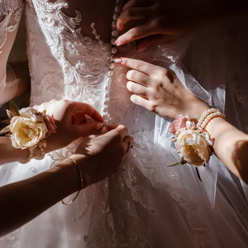 Bridesmaids helping the bride get ready