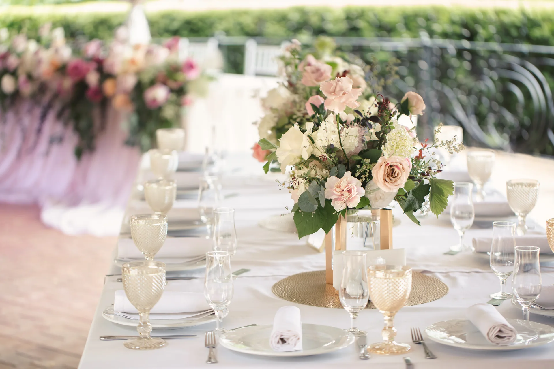 Elegant wedding reception table setting with floral centerpiece