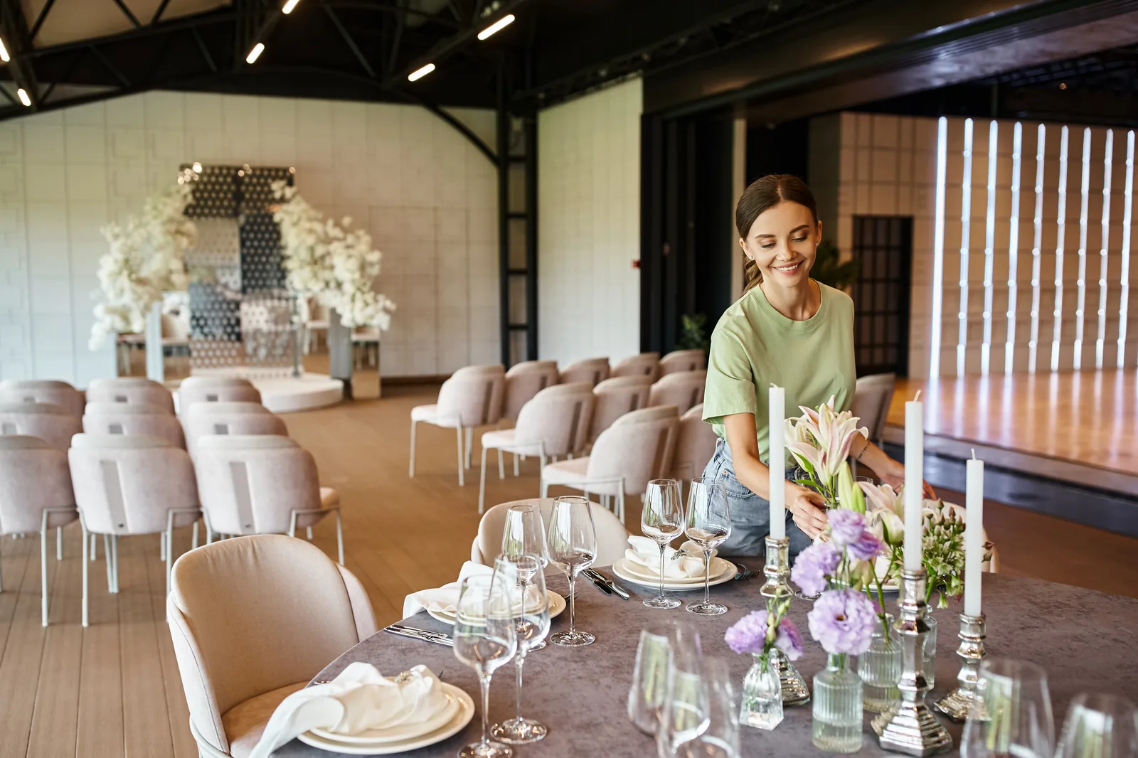Wedding planner laughing at a beautifully set reception table